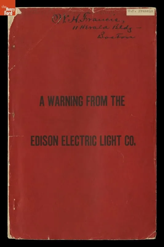 Photograph of a worn red pamphlet cover reading 'A Warning from the Edison Electric Light Co.' with a handwritten owner's name at top.